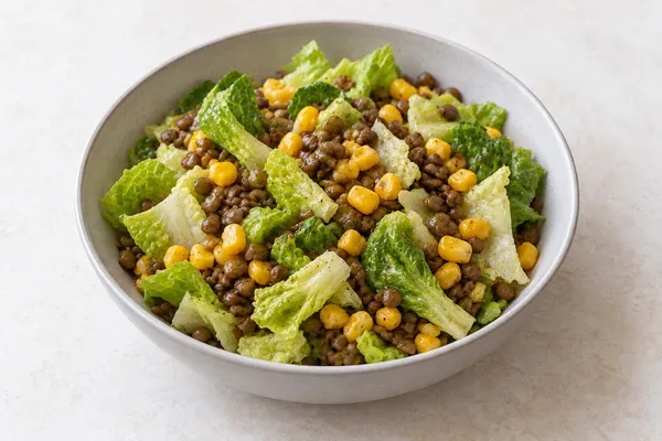 Lentils and sweetcorn with crisp romaine in a simple light ceramic bowl