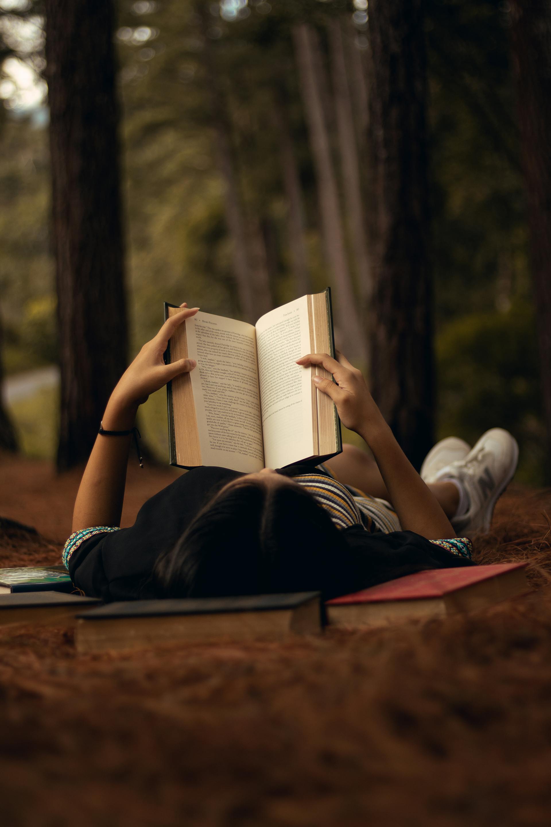 Reading a book while resting in the forest