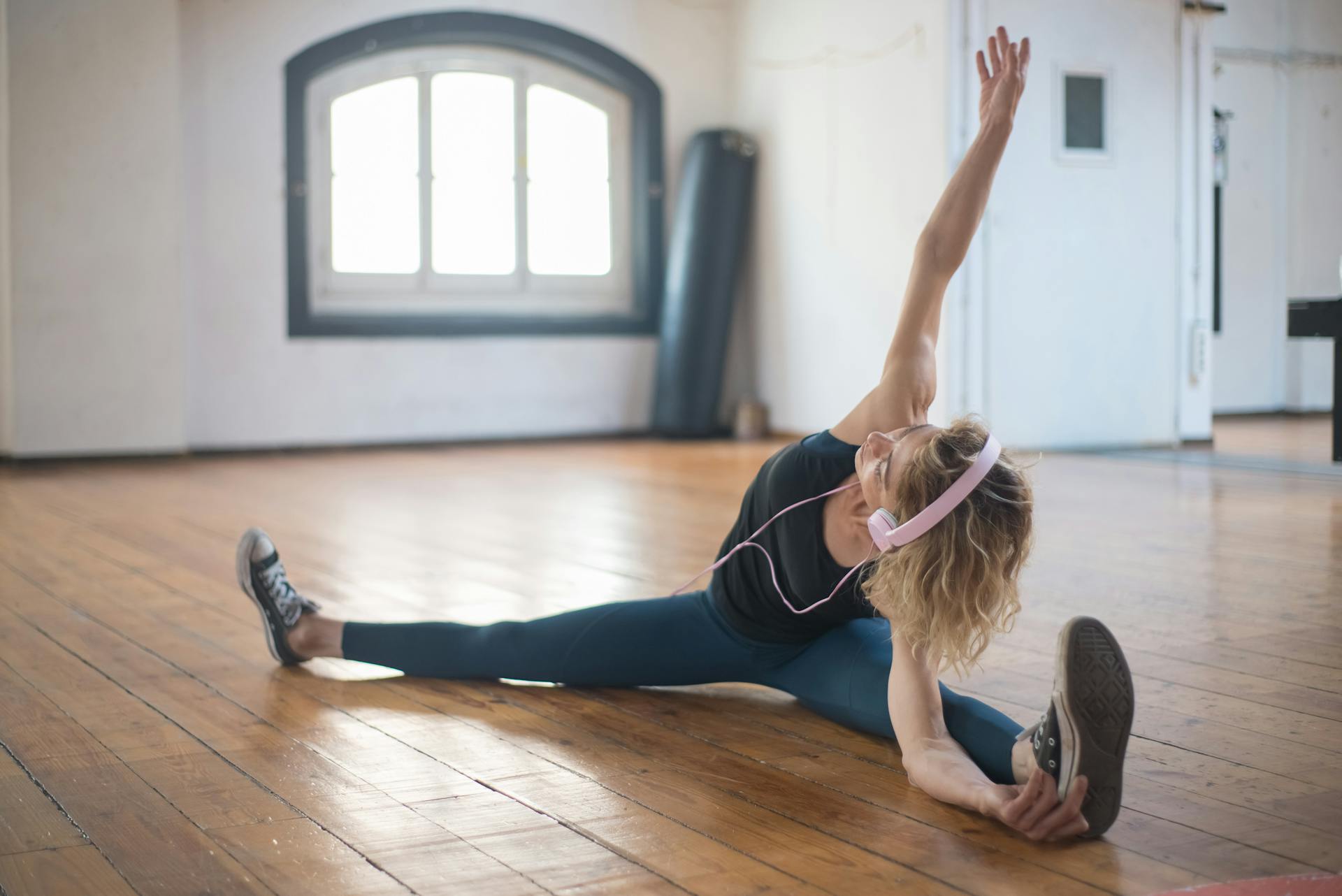 Seated stretching in a light-filled studio