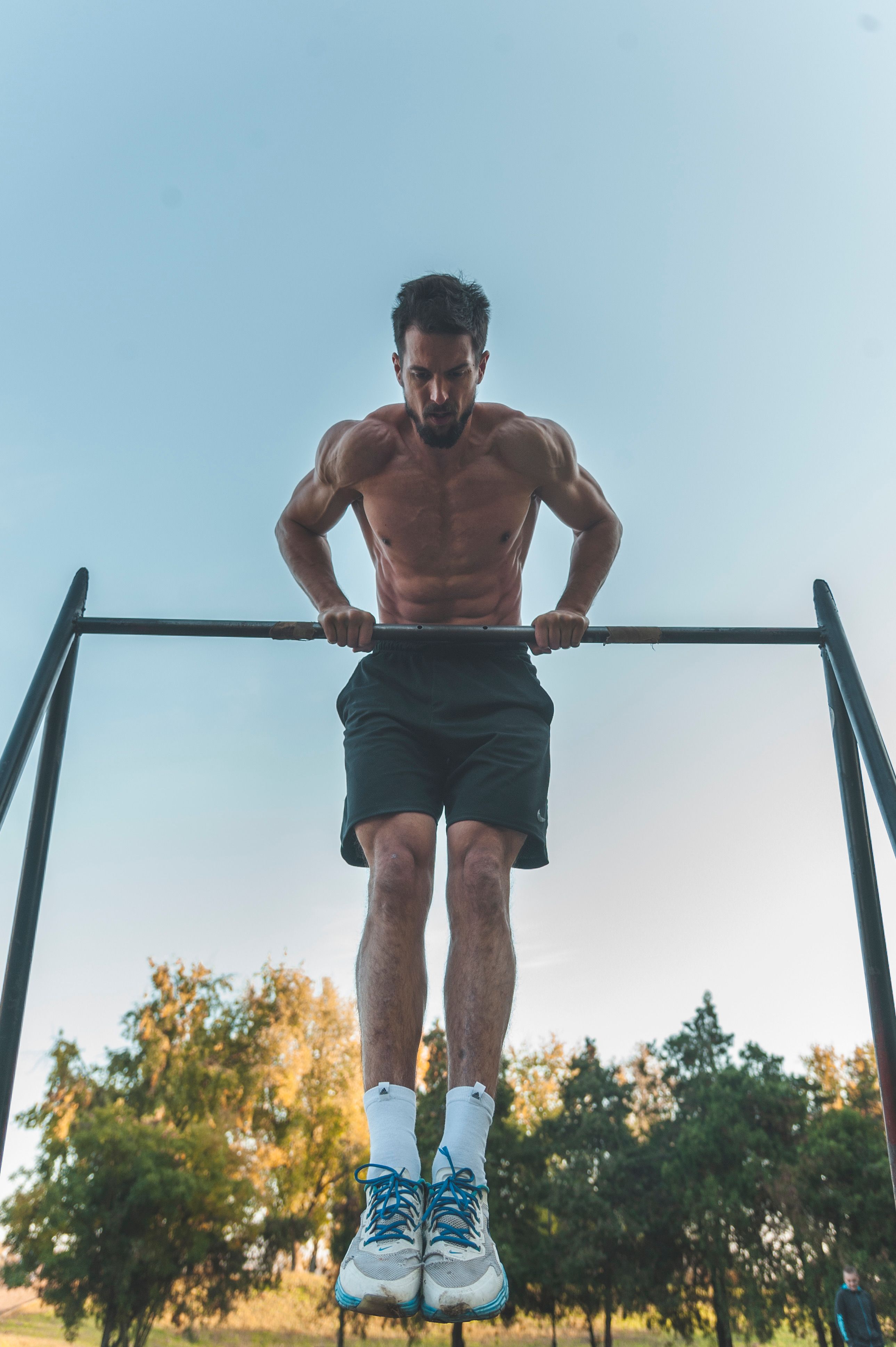 An athlete training on an outdoor bar