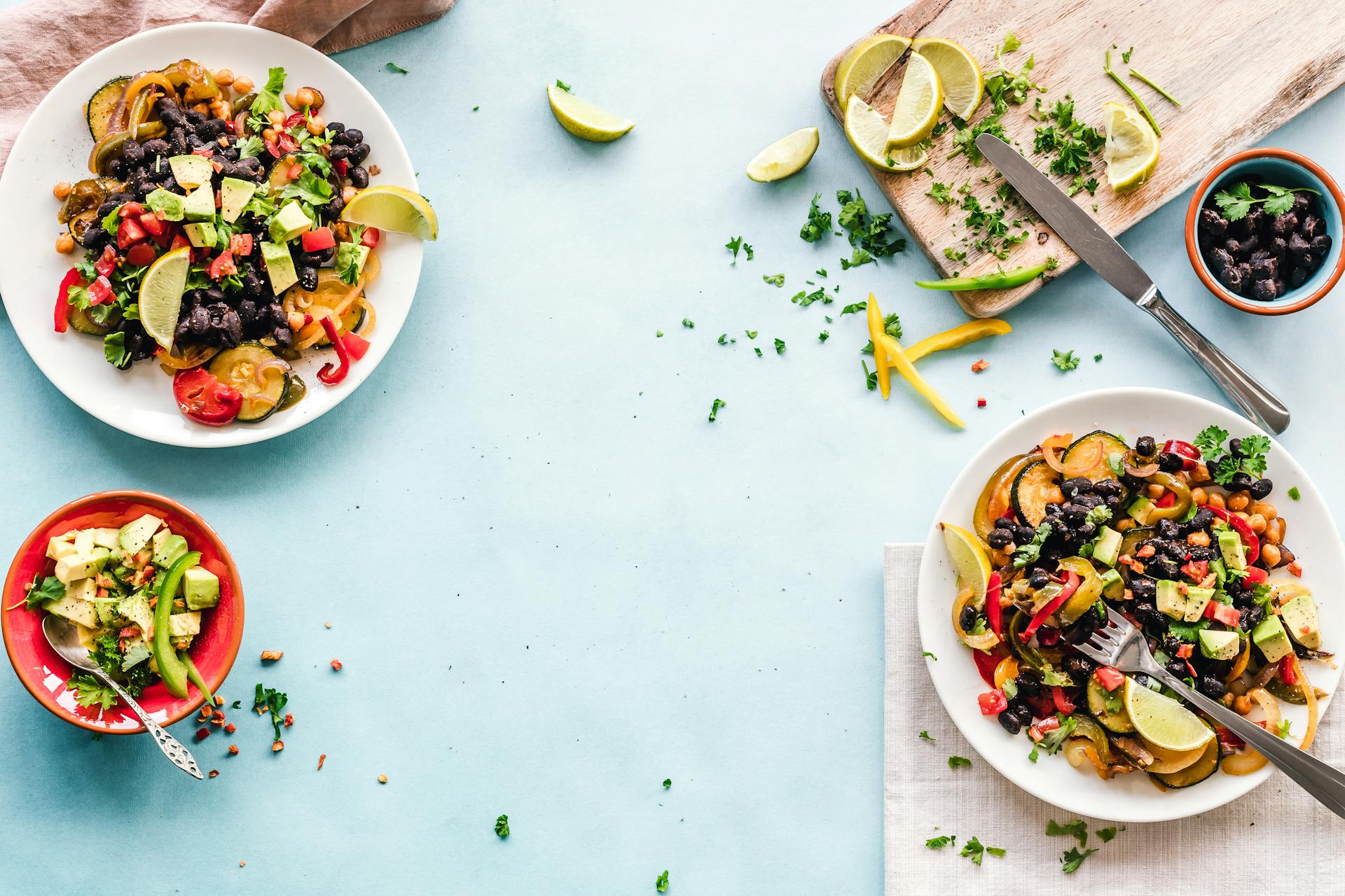 Colourful bowls of vegetables and food on a light table