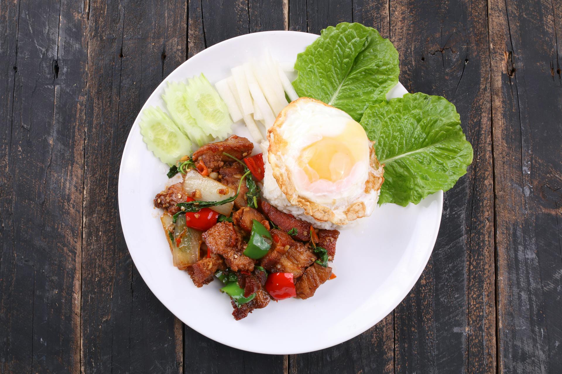A plate of rice, vegetables and an egg